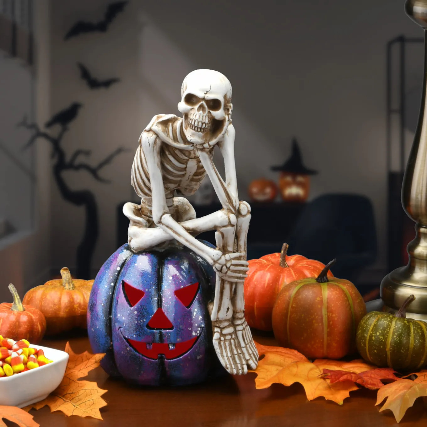 11 in. Halloween Skeleton Resting on a Purple Galaxy Jack O Lantern